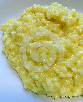 Risotto alla milanese, risotto with saffron, creamy risotto on a plate, rice dish, Italian cuisine, yellow risotto
