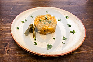 Risotto with asparagus cream on wood