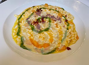 Risotto with melon scented with Ligurian basil and crunchy speck photo