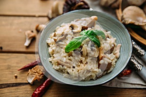 Risotto with mushrooms on an old wooden background.