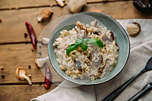 Risotto with mushrooms on an old wooden background.