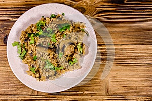 Risotto with mushrooms and paesley in a plate. Top view