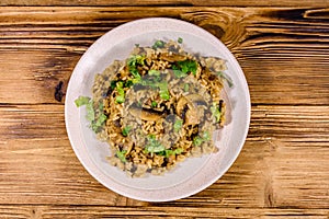 Risotto with mushrooms and paesley in a plate. Top view