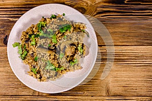 Risotto with mushrooms and paesley in a plate. Top view