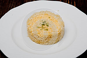 Risotto of wheat on a white plate