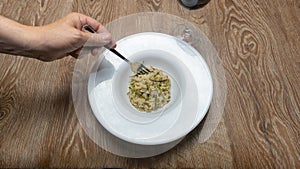 risotto with wild asparagus ,asparagus acutifolius, on white plate