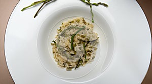 risotto with wild asparagus ,asparagus acutifolius, on white plate