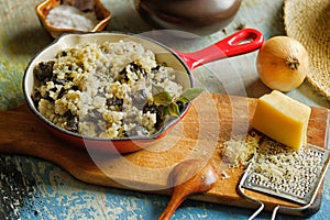 Risotto with wild mushroom served little red pan