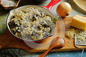 Risotto with wild mushroom served little red pan