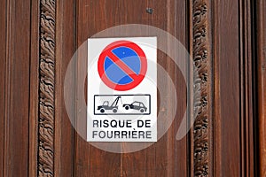 Risque de fourriere sign evacuation french text means risk car impound front of personal home entrance door garage photo