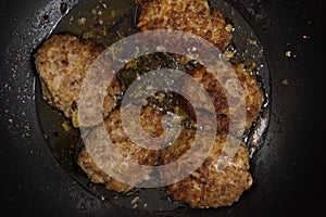 Rissole are fried in a pan. Minced meat with vegetables and buckwheat with eggs. Culinary background