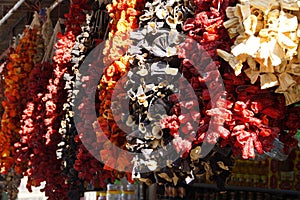 Ristras of dried eggplant and peppers hanging in the bazaar