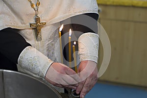 The rite of baptism. Priest prepare to baptize the child. Font for taking faith.The hands of the priest near the Epiphany bath photo