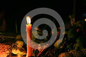 Ritual candles flanking with incense,lotus and other flowers photo
