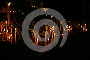 Ritual candles flanking with lotus and other flowers