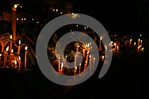 Ritual candles flanking with lotus and other flowers photo