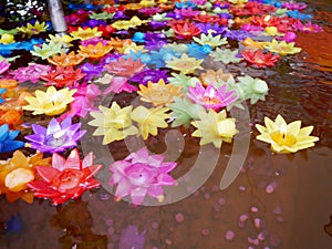 Ritual praying colorful candle floating on water for pray buddha