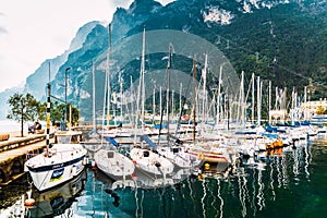 Riva del Garda, Italy - October 2, 2021: Boats and yachts moored in the port of Riva on the Italian lake