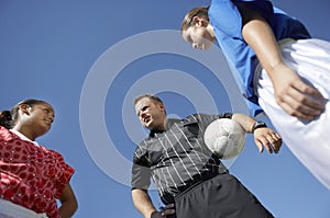 Rival Female Players In Front Of Soccer Referee photo