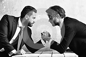 Rivalry concept. Businessmen arm wrestling.