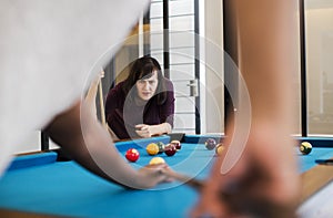 Rivalry couple playing a game of pool