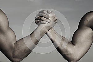 Rivalry, vs, challenge, strength comparison. Two men arm wrestling. Arms wrestling, competition. Rivalry concept - close