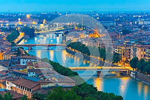 River Adige and bridges in Verona at night, Italy photo