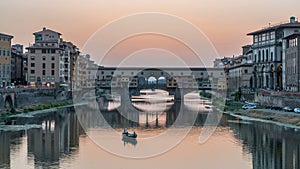 River Arno and famous bridge Ponte Vecchio day to night timelapse after sunset in Florence, Tuscany, Italy