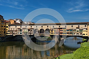 River Arno and famous bridge Ponte Vecchio The Old Bridge at sunny summer day. Florence, Tuscany, Italy