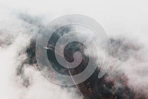 River among the autumn forest and fog, top view