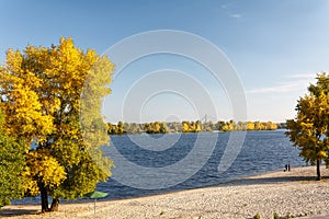 River autumn landscape with bright blue sky