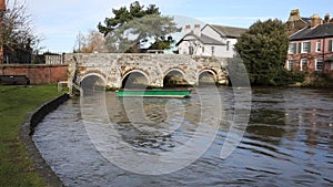 River Avon Christchurch Dorset England UK with bridge and water flowing towards the camera near to Bournemouth