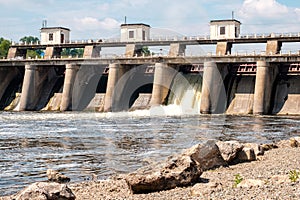 River Bank after the dam rocks on the shore and the rushing water