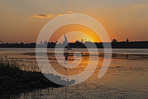 River bank  and felluca silhouette at dusk sunset