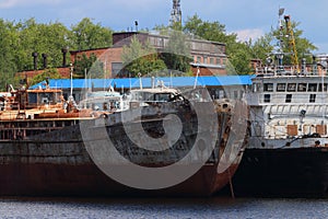 River bay with rusty cargo ships