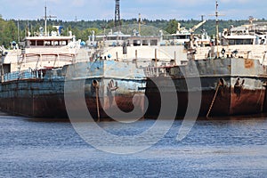River bay with rusty cargo ships