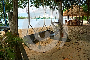 River beach with straw hut and swing in Kampot Cambodia