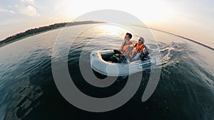 River is being crossed by two men in the inflatable boat