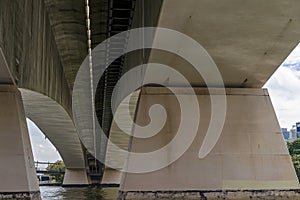 River Boat Cruise Under Concrete Bridge Span