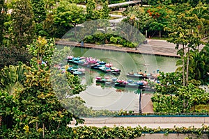 River with boats on it surrounded by greenery in the Gardens by the Bay in Singapore