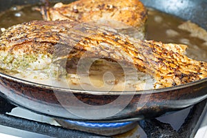 River bream fish is frying on the pan in oil