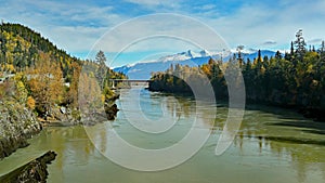 River, bridge and forests with snow capped mountains