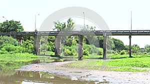 A river bridge in Thailand that is dry and less watery.