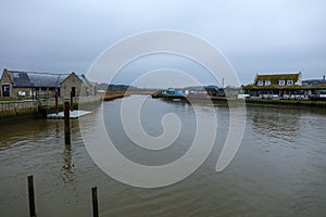 River Brit on a mist raining day with overcast and buildings. Panoramic view. West Bay, Dorset, UK photo