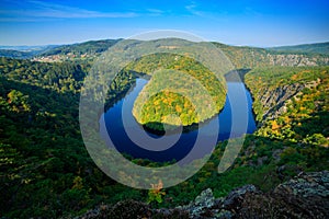 River canyon with dark water and green forest. Horseshoe bend, Vltava river, Czech republic, Europe. Beautiful landscape with rive