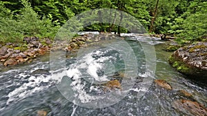 River in Caucasus mountains forest, near lake