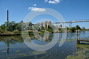 River & cement works, overhead conveyor. UK