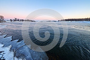 The river and covered with ice sunset