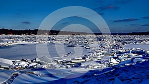 River covered with piles of ice smithereens photo