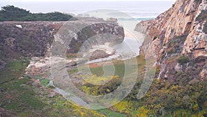 River creek estuary in canyon, mountain cliff or bluff. California ocean coast.